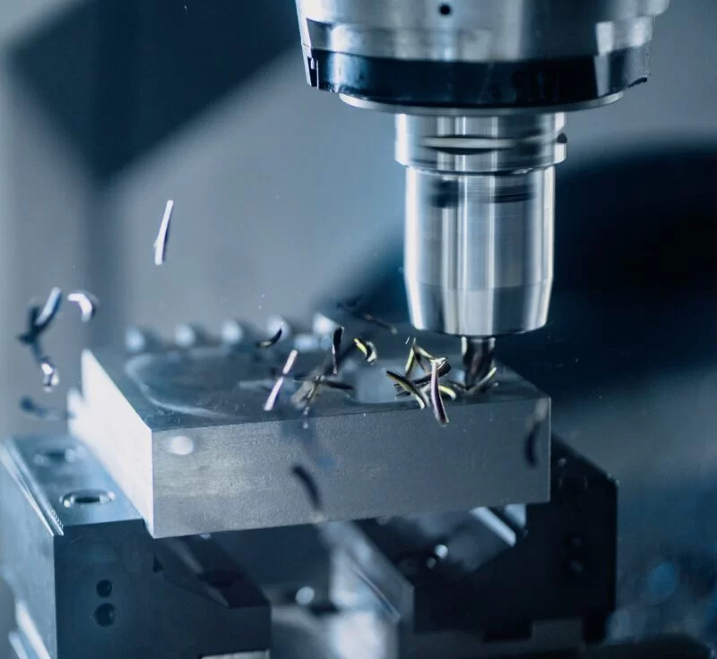 CNC machine drilling into metal